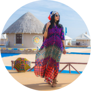 Traveler in colorful traditional attire walking through a cultural village in the Rann of Kutch.
